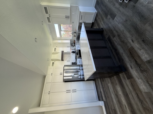 Two-tone kitchen cabinets with dark island and white perimeter