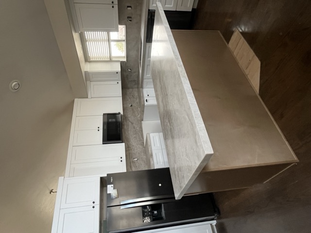 White cabinets with gray marble quartz countertop and matching backsplash
