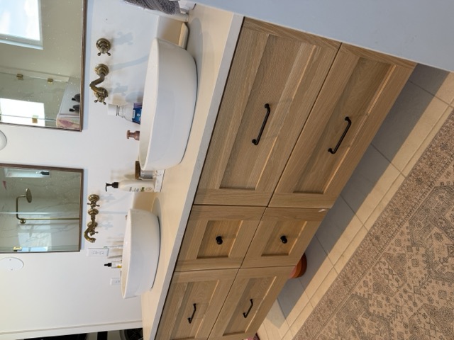 Custom bathroom vanity with vessel sinks and brass wall-mount faucets