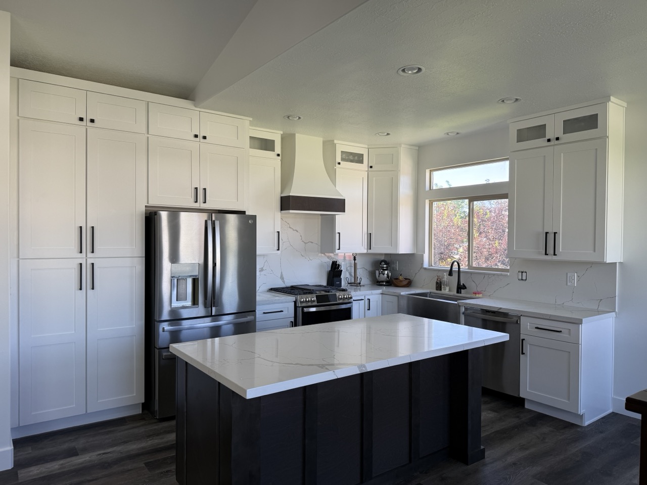 Modern white shaker kitchen with dark island by Salt City Cabinet & Design